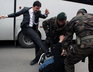 Turkish prime minister advisor kicking a protester